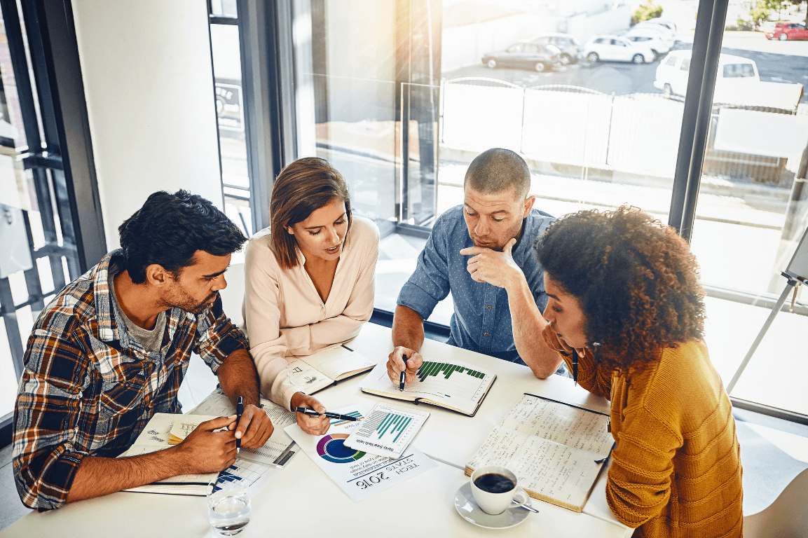 A group of leaders chatting around a table.